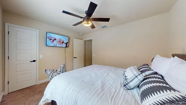 a bedroom with a bed and a chandelier