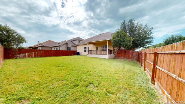 a view of an house with backyard and balcony