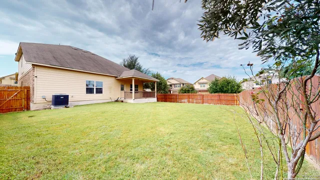 a backyard of a house with table and chairs