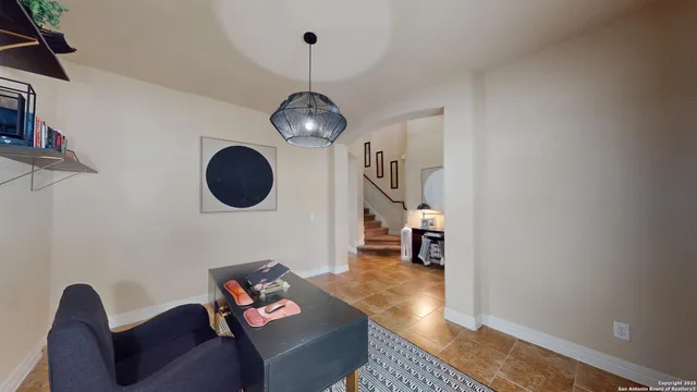 a living room with furniture and a mirror