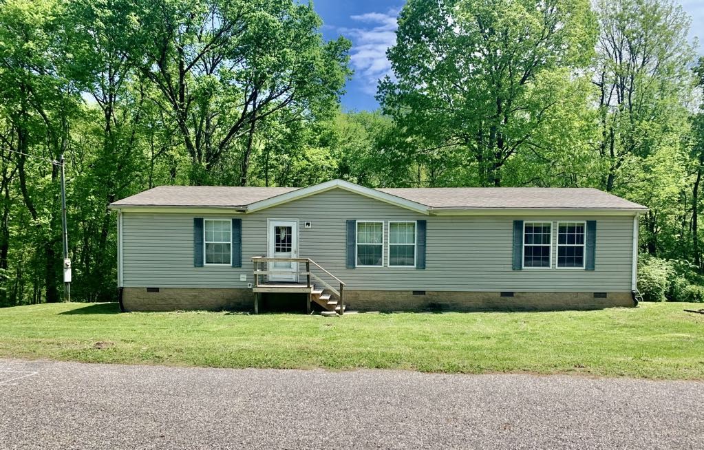 8603 Crawley Hill Rd Mount Mount Pleasant, TN 38474 - Photo 1 of 12 a front view of house with yard and trees