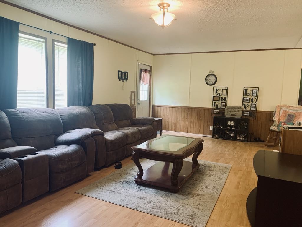 8603 Crawley Hill Rd Mount Mount Pleasant, TN 38474 - Photo 3 of 12 a living room with furniture and a large window