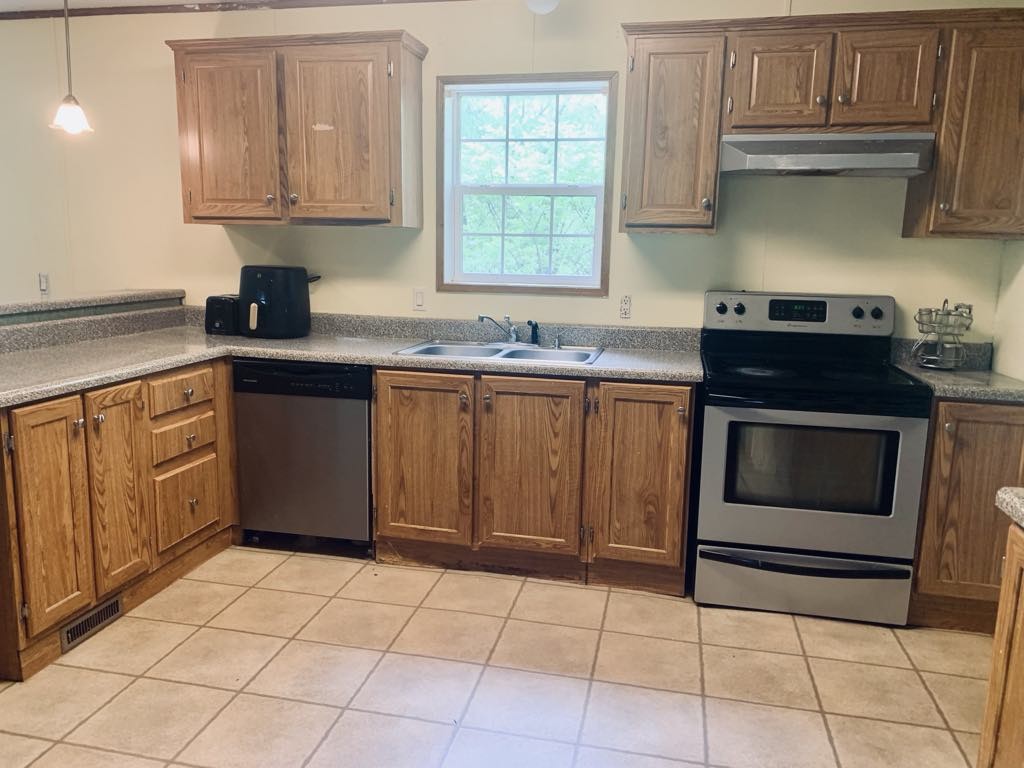 8603 Crawley Hill Rd Mount Mount Pleasant, TN 38474 - Photo 6 of 12 a kitchen with a stove sink and cabinets