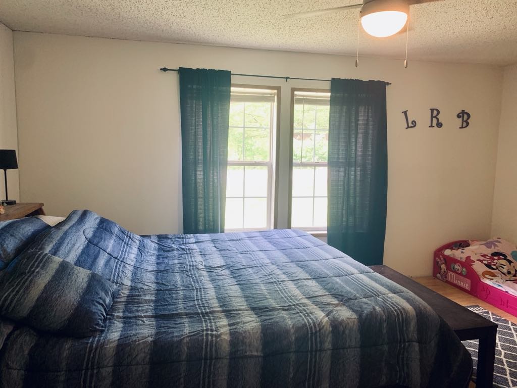 8603 Crawley Hill Rd Mount Mount Pleasant, TN 38474 - Photo 10 of 12 a bedroom with a bed and a window
