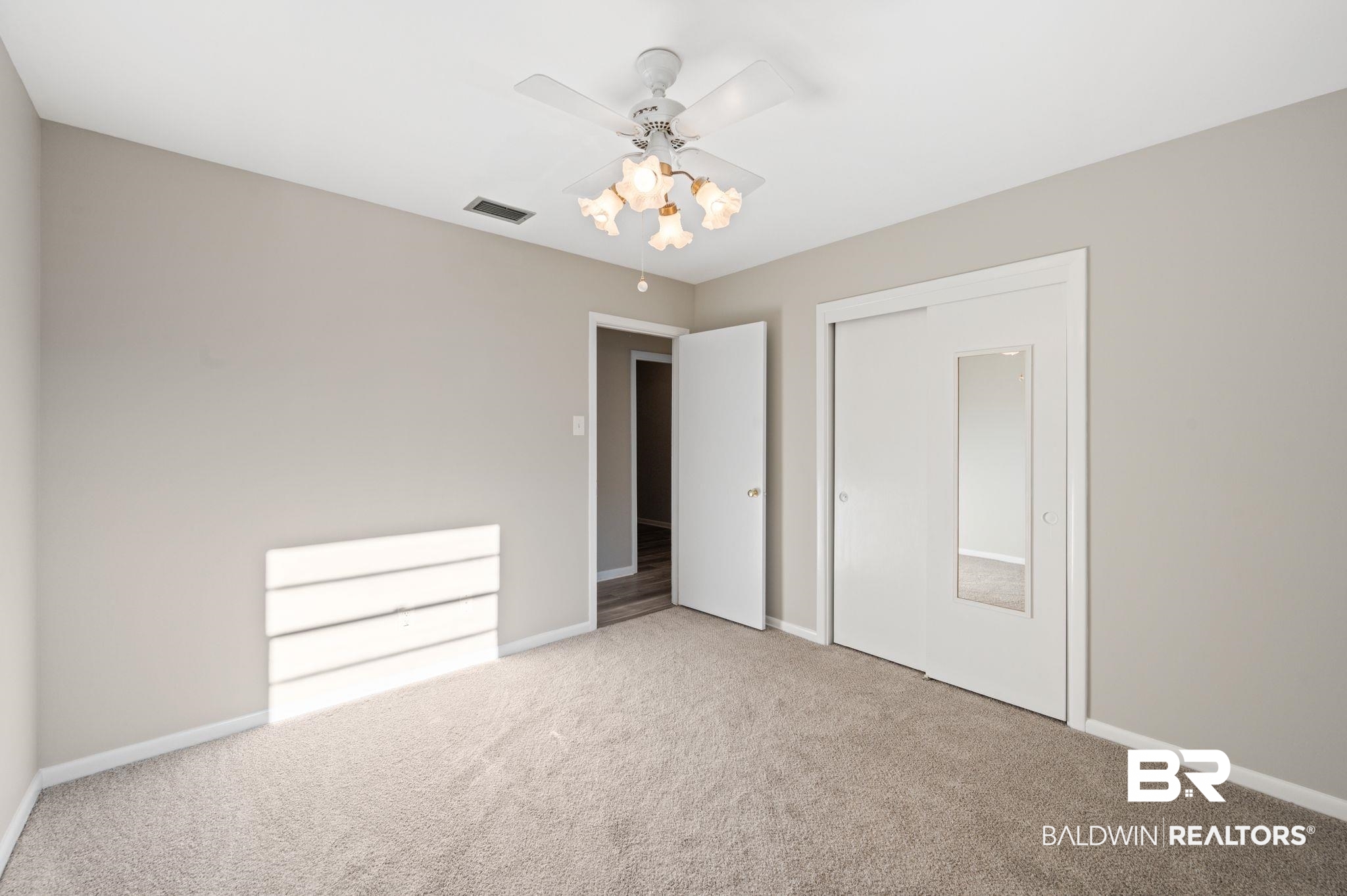 909 Caroline Avenue Daphne, AL 36526 - Photo 28 of 46 Unfurnished bedroom with carpet floors, a closet, and ceiling fan
