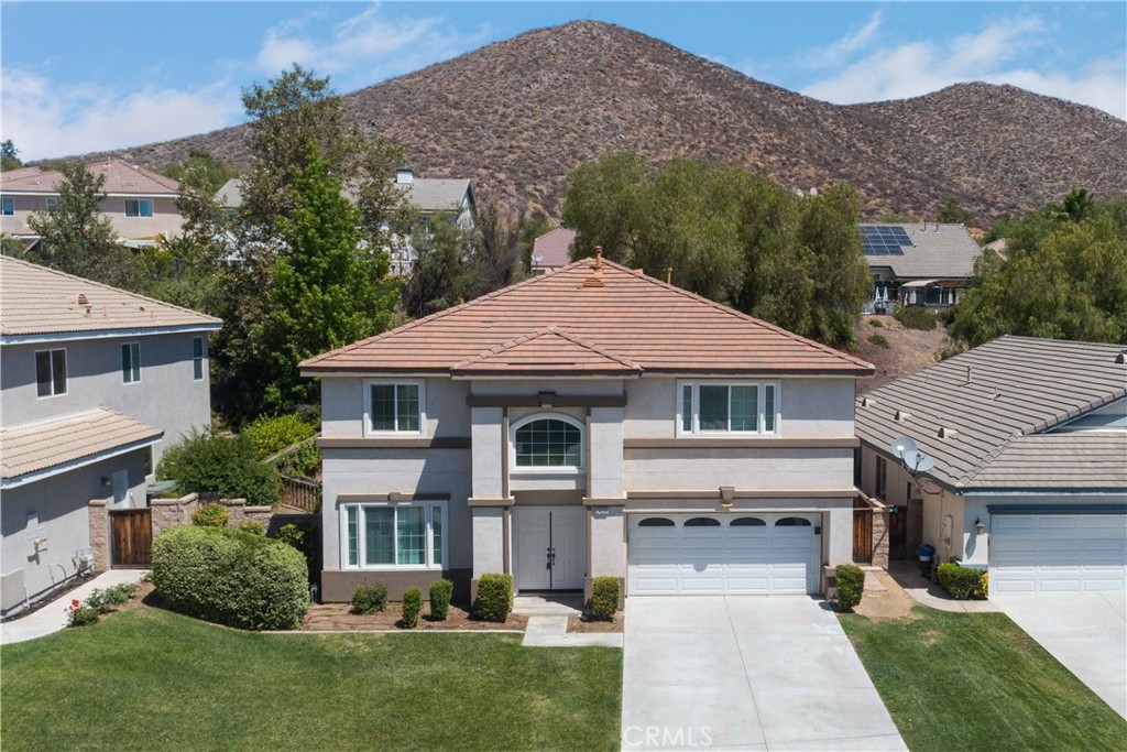 a front view of a house with a yard and a garage