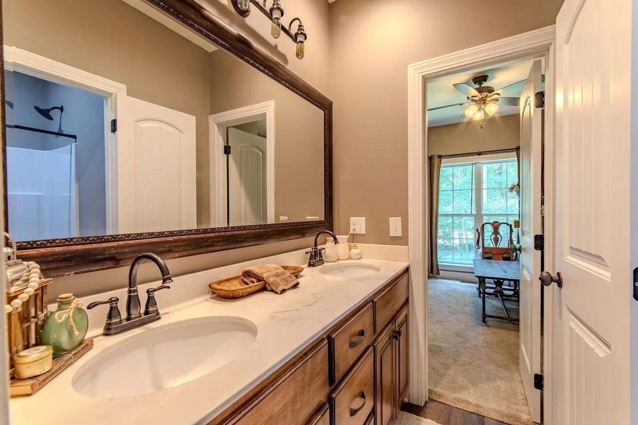 2134 Otis Plunk Road Bethel Springs, TN 38315 - Photo 15 of 35 a en suite bathroom with a double vanity sink and a mirror