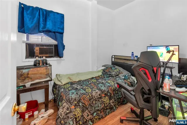 a bedroom with a bed closet and flat tv screen