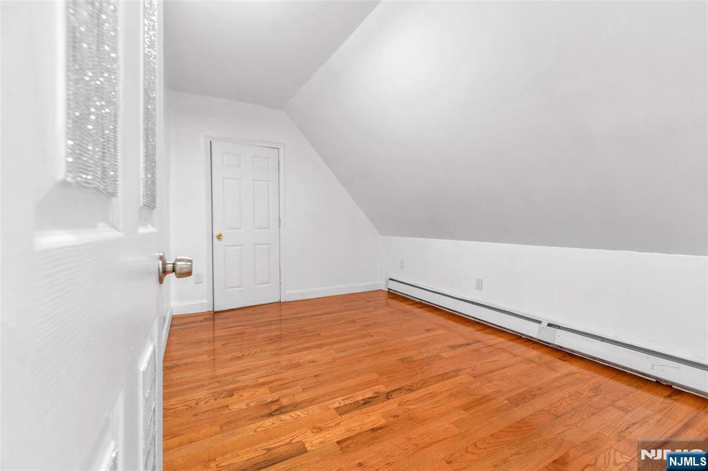 25 Oak Street Paterson, NJ 07501 - Photo 12 of 25 a view of a room with wooden floor and white walls