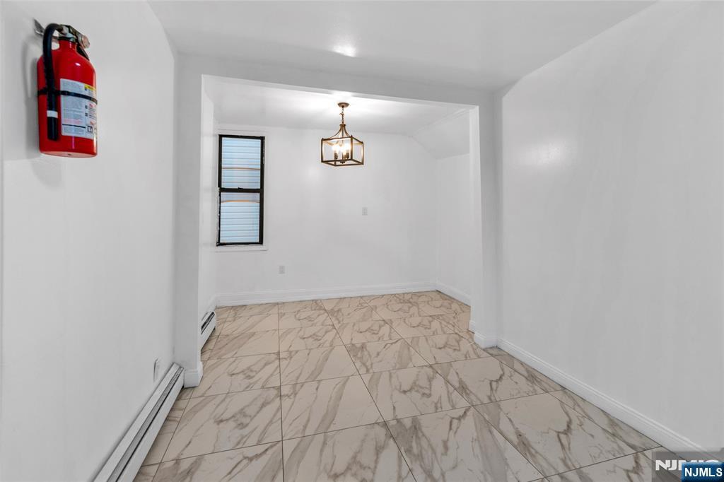 25 Oak Street Paterson, NJ 07501 - Photo 15 of 25 a bathroom with a bathtub and shower