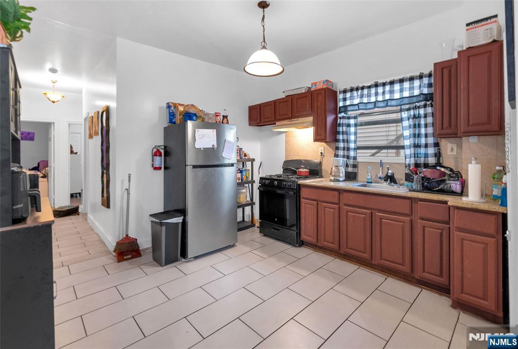 25 Oak Street Paterson, NJ 07501 - Photo 4 of 25 a kitchen with refrigerator and window