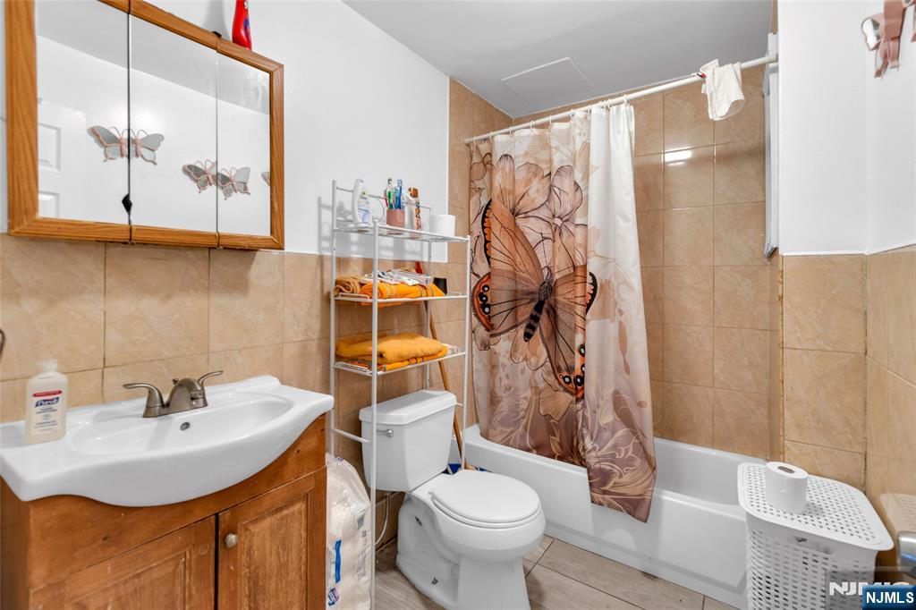 25 Oak Street Paterson, NJ 07501 - Photo 6 of 25 a bathroom with a sink toilet and mirror