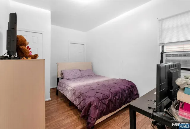 a bedroom with a bed and a tv