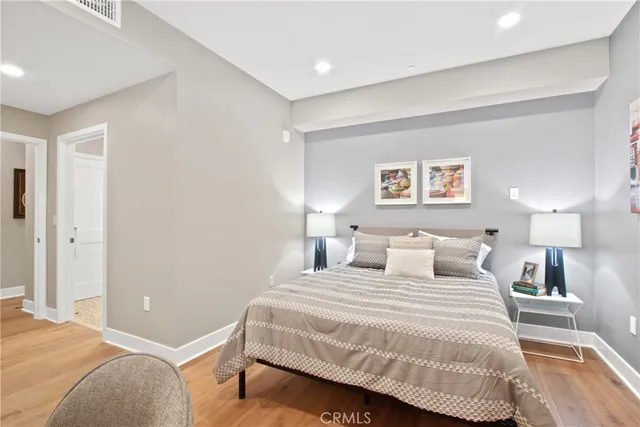 a bedroom with a bed and a night stand