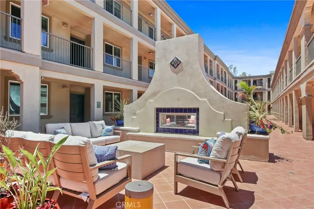 a view of a patio with couches table and chairs and potted plants