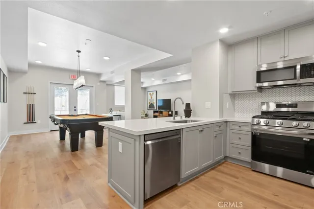 a kitchen with a stove a sink and a refrigerator