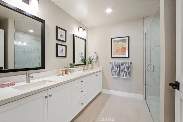 a bathroom with 2 sink tub and a mirror