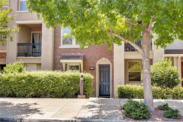 front view of a house with a tree
