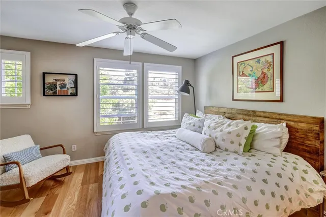 a bedroom with a bed and a painting on the wall