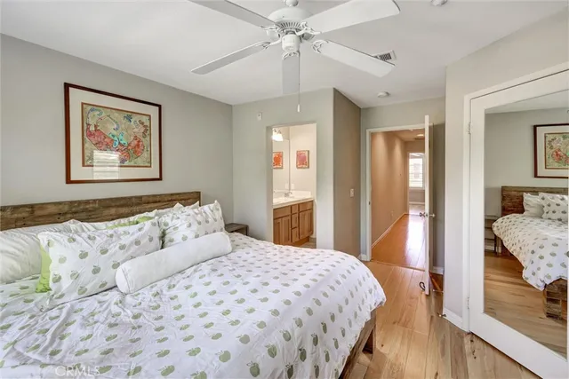 a bedroom with a large bed and a chandelier