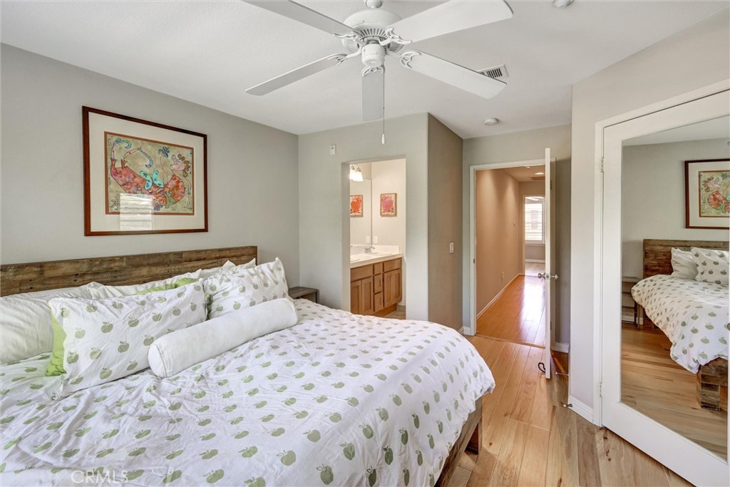 1159 Elfin Forest Road San Marcos, CA 92078 - Photo 25 of 40 a bedroom with a large bed and a chandelier