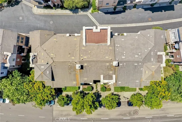 an aerial view of a house with a yard and plants