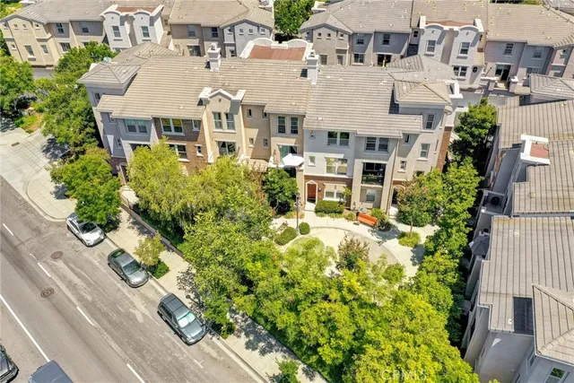 an aerial view of multiple houses with yard