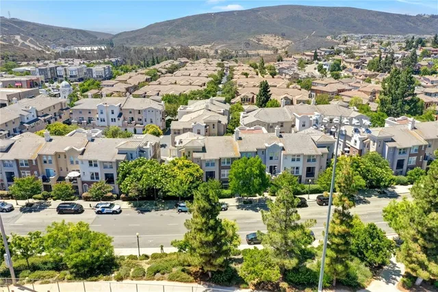 an aerial view of residential houses with outdoor space