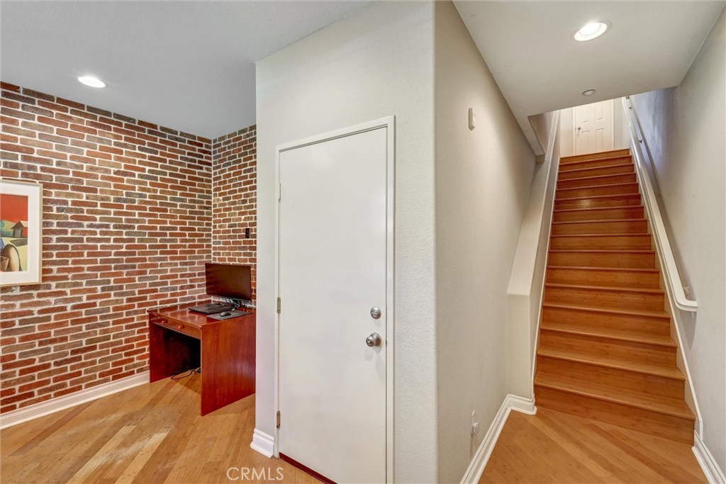 1159 Elfin Forest Road San Marcos, CA 92078 - Photo 9 of 40 a view of a hallway with wooden floor and staircase