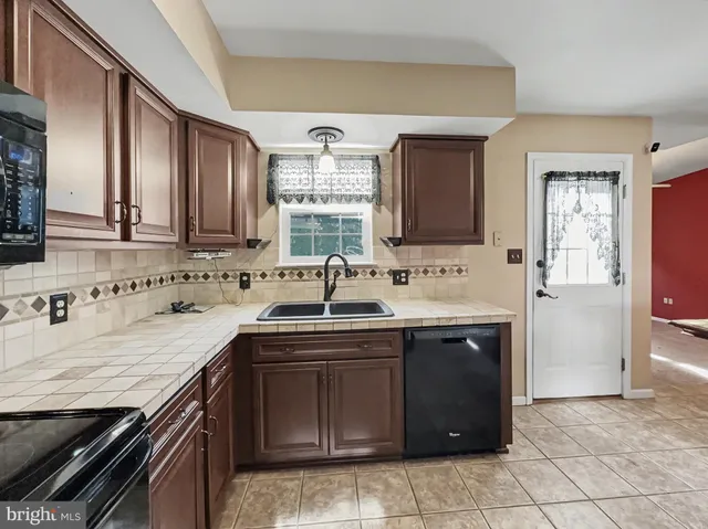a kitchen with a sink and a stove top oven