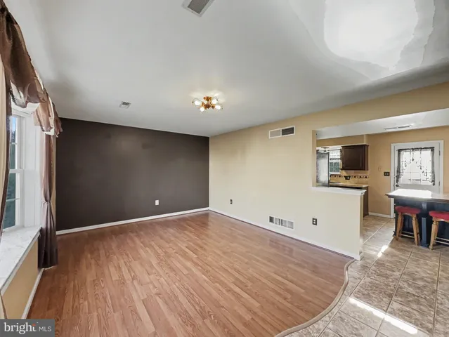 a view of livingroom with hardwood floor and kitchen view