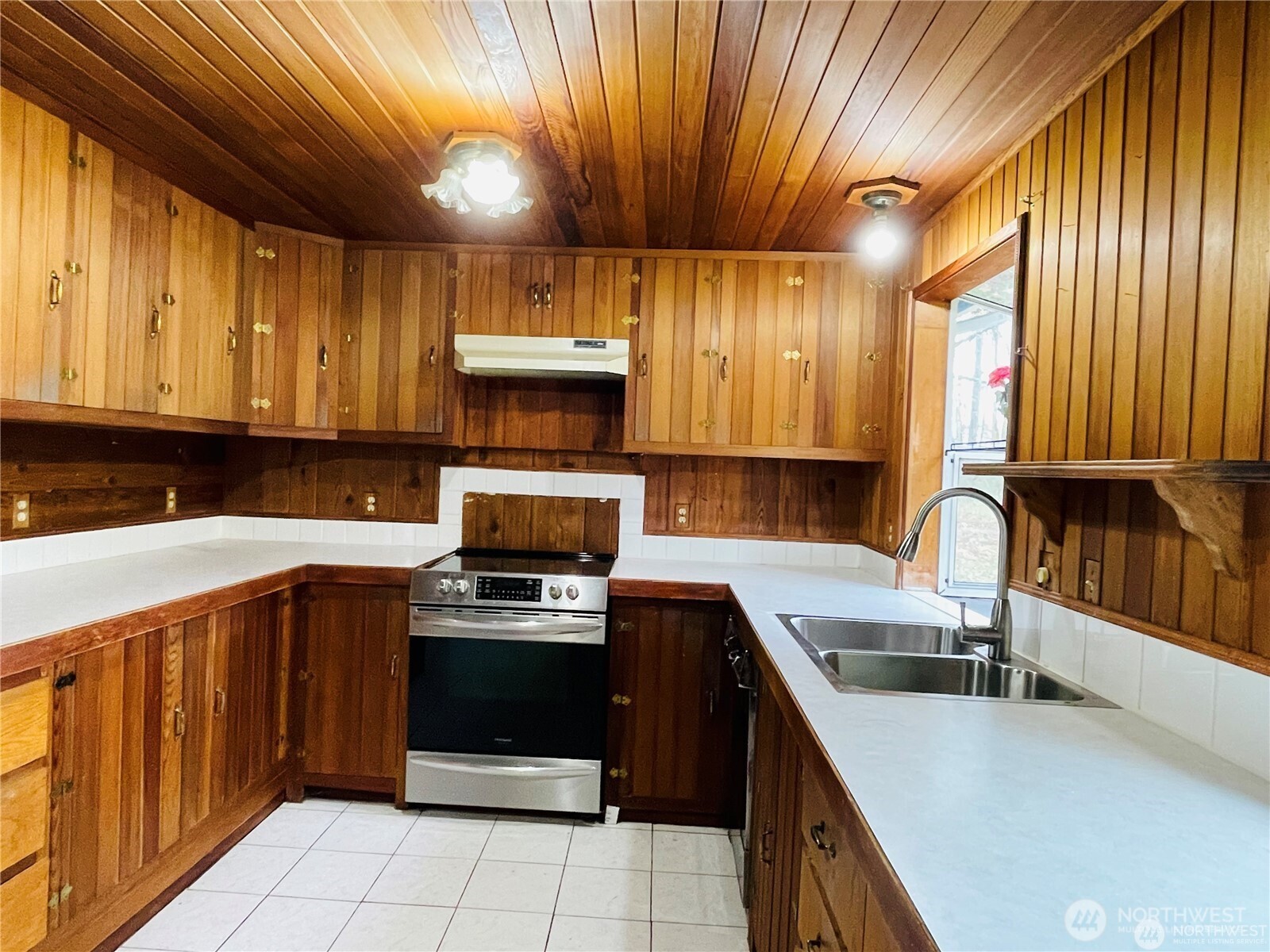 15407 264th Street East Graham, WA 98338 - Photo 7 of 23 a kitchen with a sink a stove and cabinets