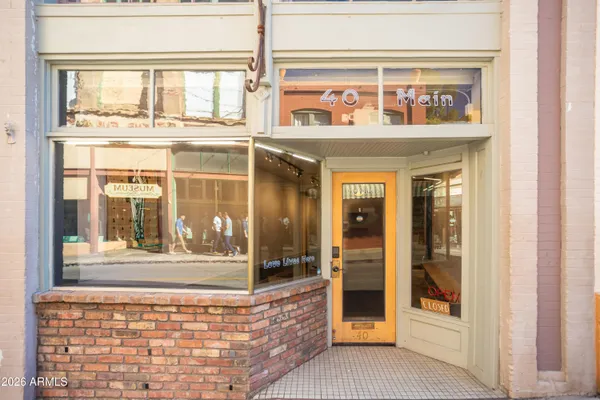a view of a brick house with large windows