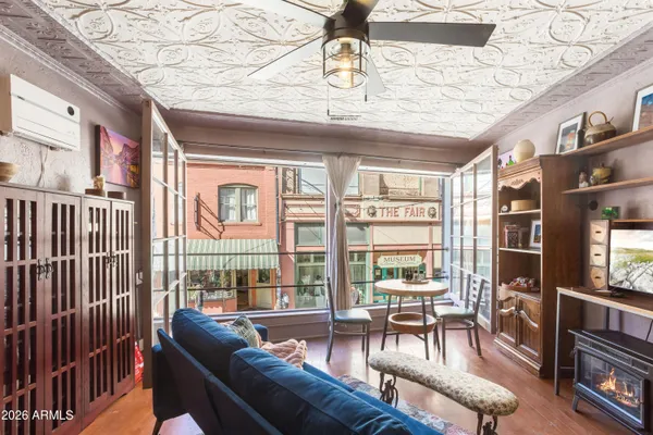 a living room with furniture and a floor to ceiling window