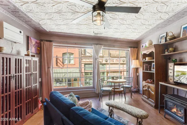 a living room with furniture and a floor to ceiling window