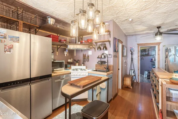 a kitchen with refrigerator and cabinets