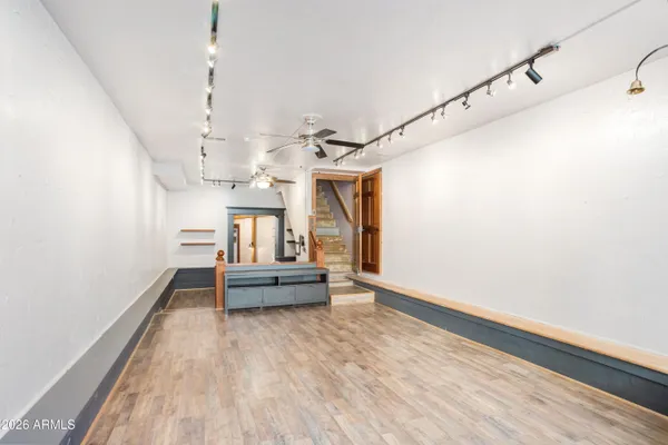 a view of entryway and hall with wooden floor