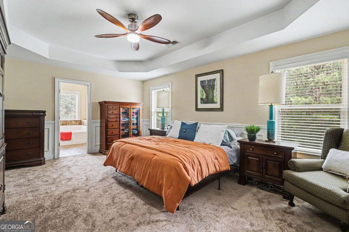 207 George Wynn Road Palmetto, GA 30268 - Photo 17 of 32 a bedroom with a bed and a chandelier