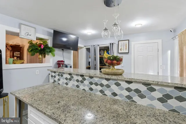 a living room with a couch and potted plant