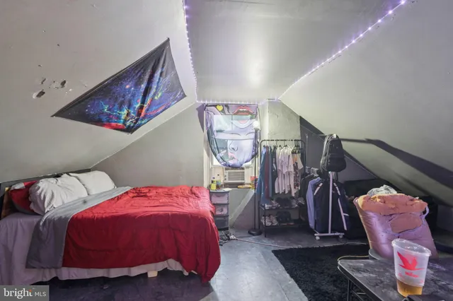 a bedroom with two bed and a view of bathroom