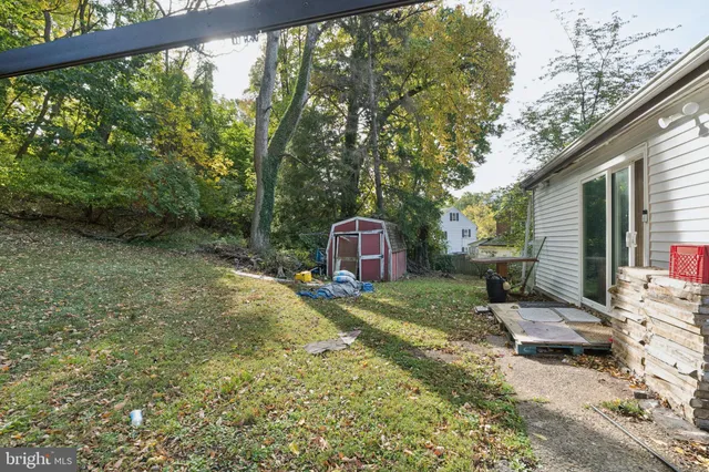 a backyard of a house with a garden and barbeque oven