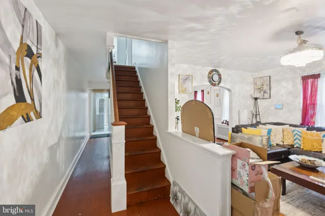 a view of entryway with furniture and wooden floor