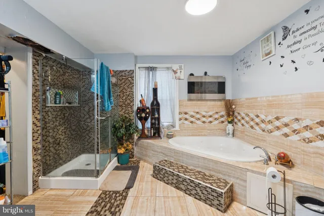 a bathroom with a bathtub and shower