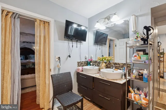 a bathroom with a sink a mirror and shower