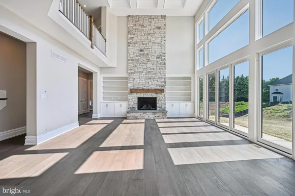 a large kitchen with stainless steel appliances granite countertop a lot of counter space and wooden floors