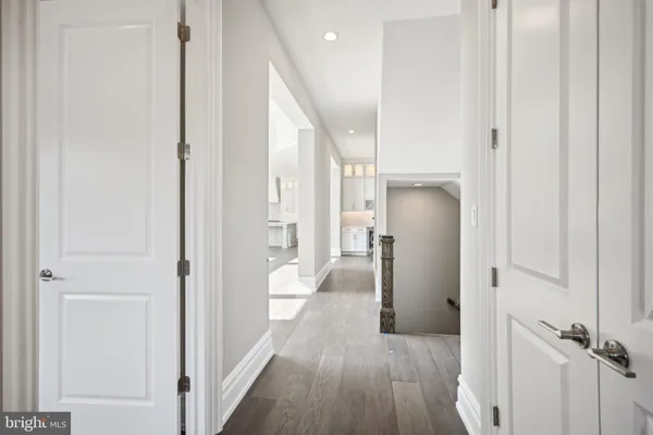 a spacious bathroom with a double vanity sink a mirror and a bathtub