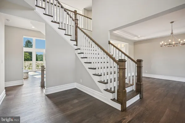 a view of entryway with wooden floor and stairs