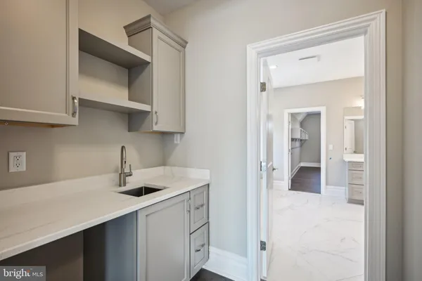 an empty room with a kitchen and fire place