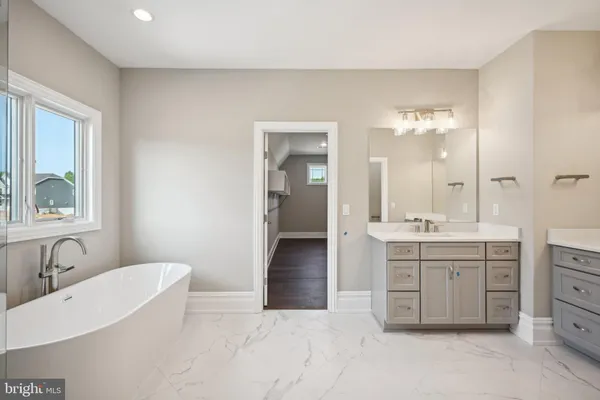 a spacious bathroom with a toilet sink and mirror