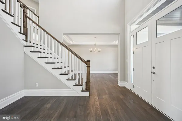 a view of entryway and hall with wooden floor